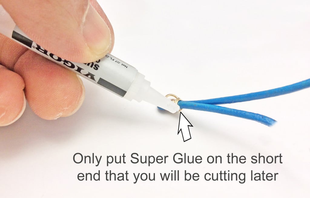 On the bottom, Be careful not to use too much super glue or the cord will become stiff and brittle.