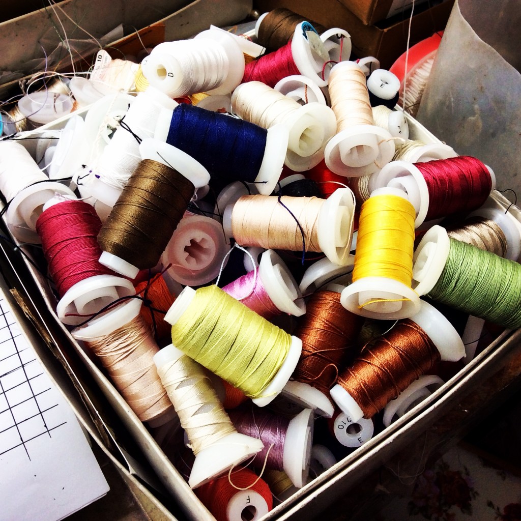 Spools of different color silk thread for beading and stringing.